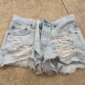 Levi’s Jean shorts with rips in front and some on back pockets.